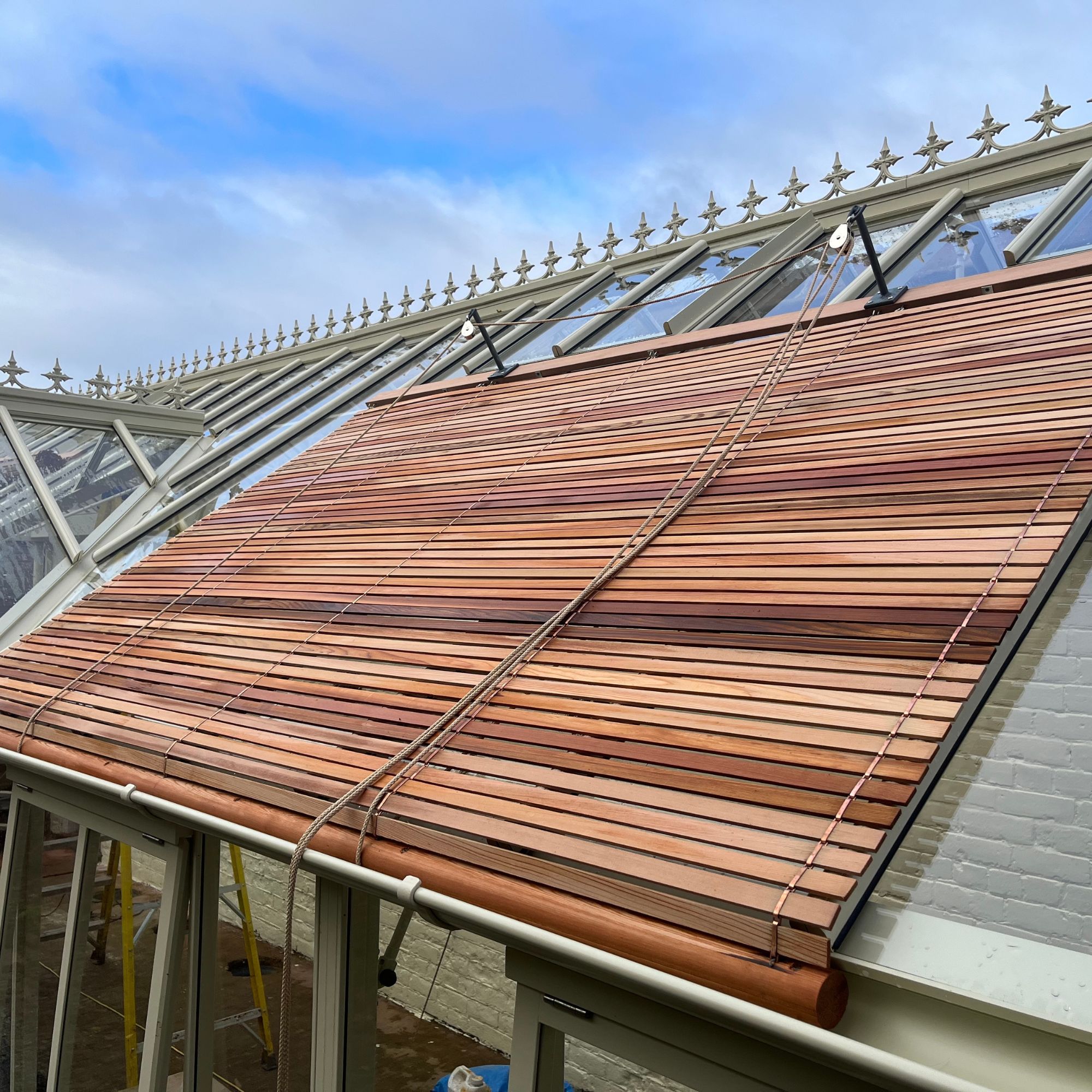 White Cottage Greenhouses hand-crafted cedar-lath blinds on a White Cottage Edwardian Greenhouse