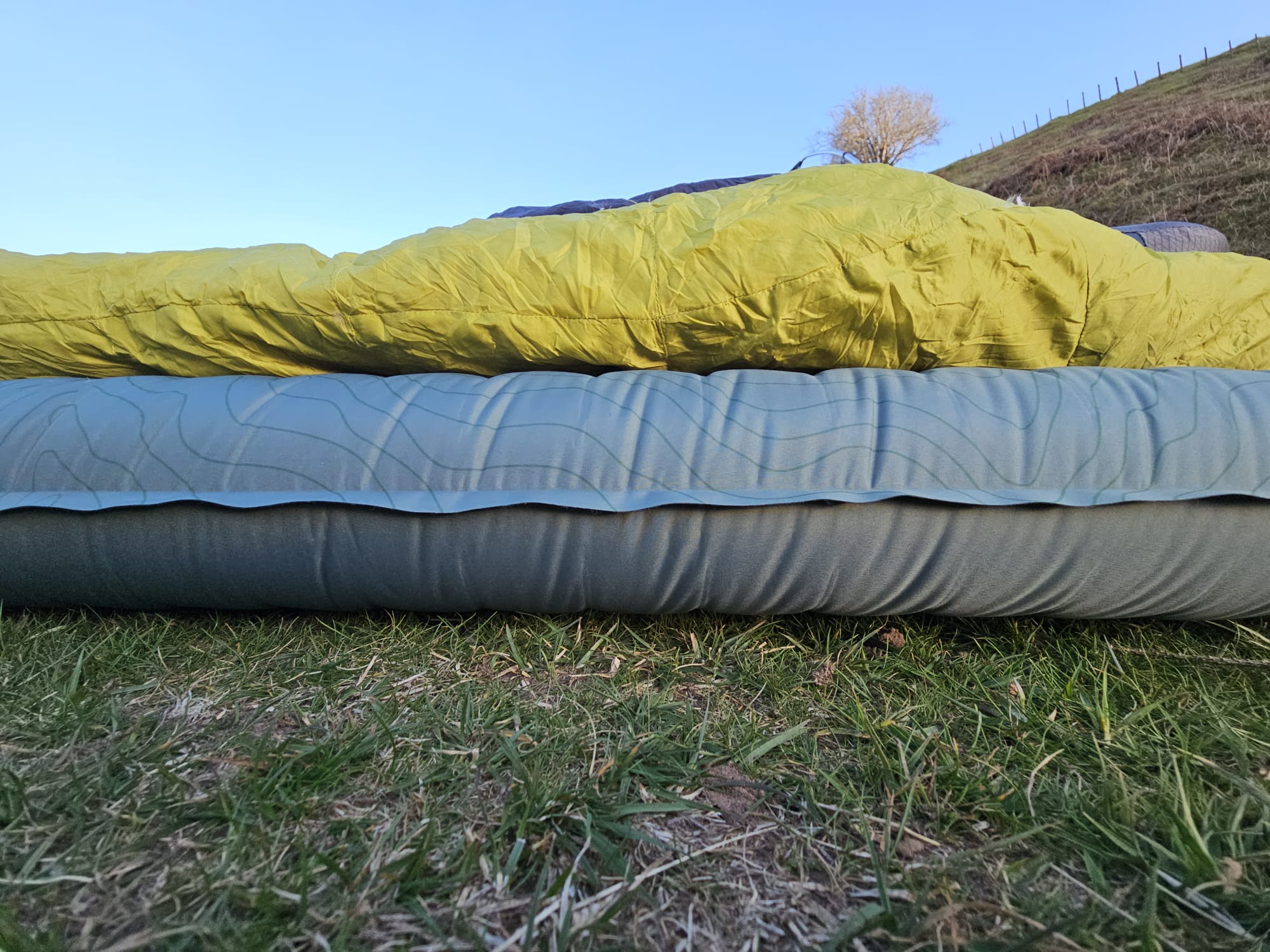 Thermarest sleeping mat shown in front of a backpacking tent
