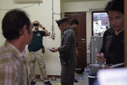 Thai police search an apartment for bomb materials on Sunday, Aug. 30