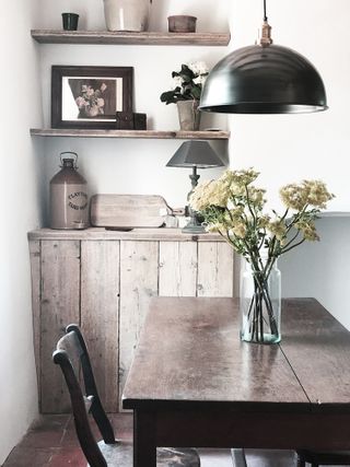 rustic dining room with reclaimed wood cupboard and shelving