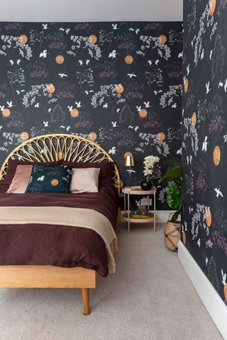 bedroom with dark gray wallpaper and rattan bedhead