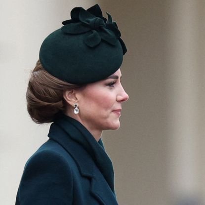 Kate Middleton wearing a green coat with a serious expression on St Patrick's Day 2025