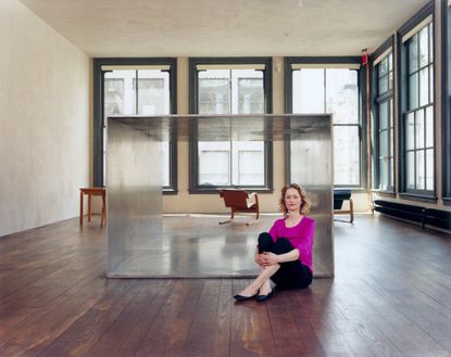 Donald Judd's home and studio in New yORK interior with woman sitting in the middle of the room