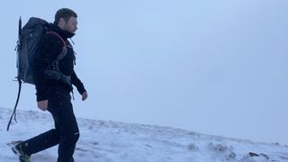 Man winter mountaineering wearing ThruDark Centurion Alpine Jacket