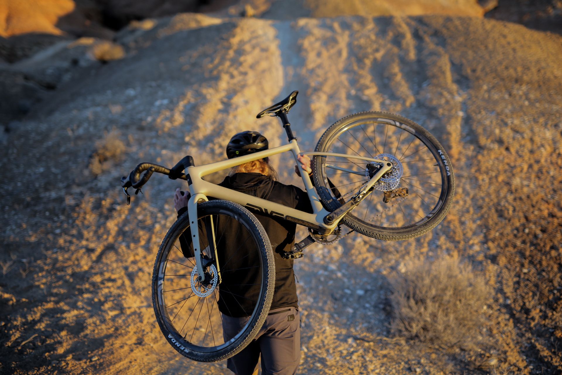 A cyclist carrying the Enve MOG across their shoulders