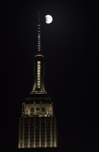 The full moon is seen next to New York City's Empire State Building at the beginning of a total lunar eclipse on Sept. 27, 2015.