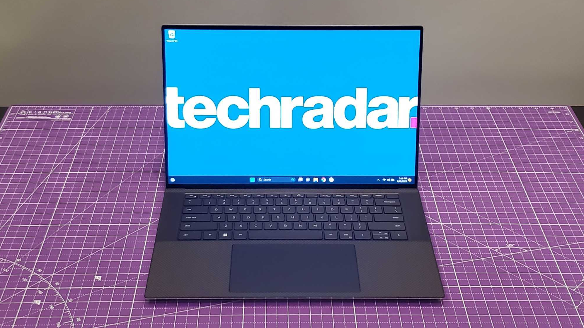 silver laptop sitting on purple desk