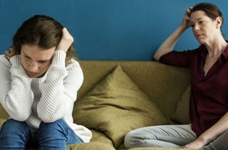 adult and child talking on sofa