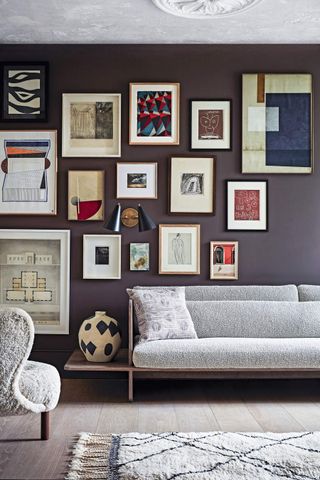 A wall filled with framed artwork