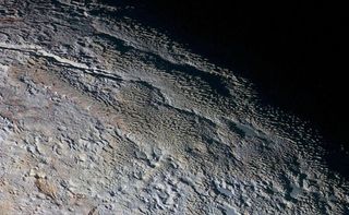 This is "bladed terrain" on Pluto seen by the New Horizons Ralph/Multispectral Visual Imaging Camera. Images of the dwarf planet appear to show terrain consistent with a feature called penitentes.
