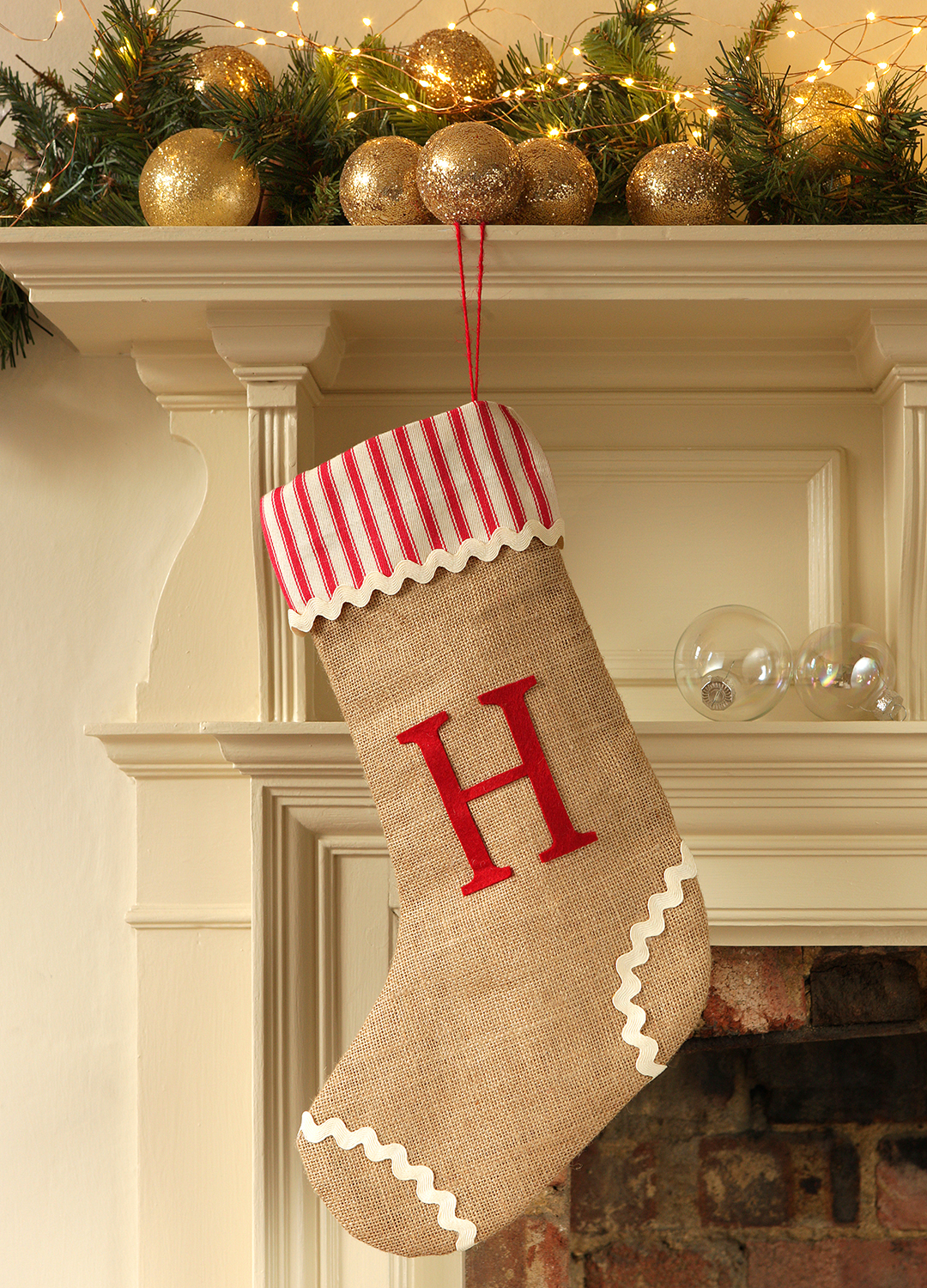 Mantlepiece with a jute stocking embroidered with the initial H