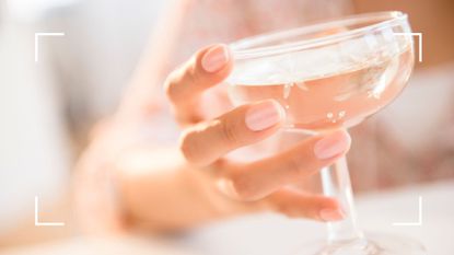 Woman holding alcoholic drink, representing low calorie vodka