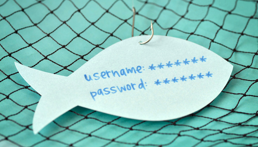 Pappfisch mit 'Benutzername' und 'Passwort' darauf geschrieben in einem Fischernetz gehakt.