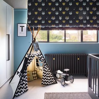 kids room with blue walls patterned blind and a teepee