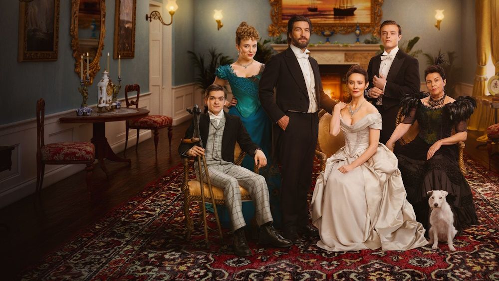 Promotional image for The Hardacres showing the primary cast dressed up in their fineries in a country house living room.