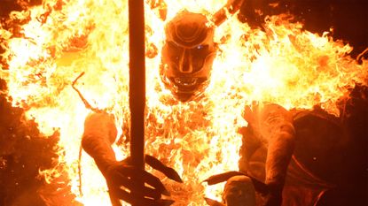 A giant figure of the devil burns during the Feast of the Immaculate Conception festival in Guatemala City, Guatemala
