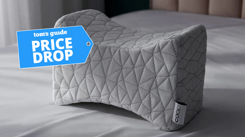 Coop Home Goods curved knee pillow on bed