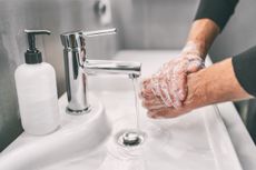 A person washing their hands with soap.