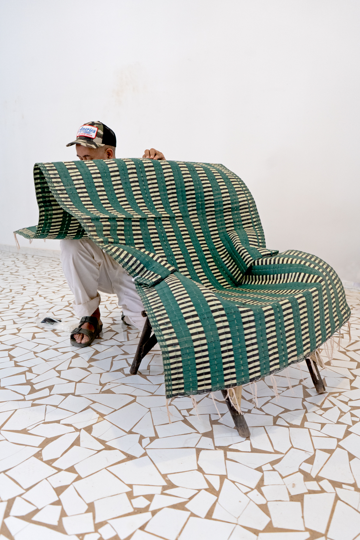 colourful woven mats folded over bamboo chairs