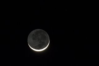 a close up of a New Moon in a dark sky