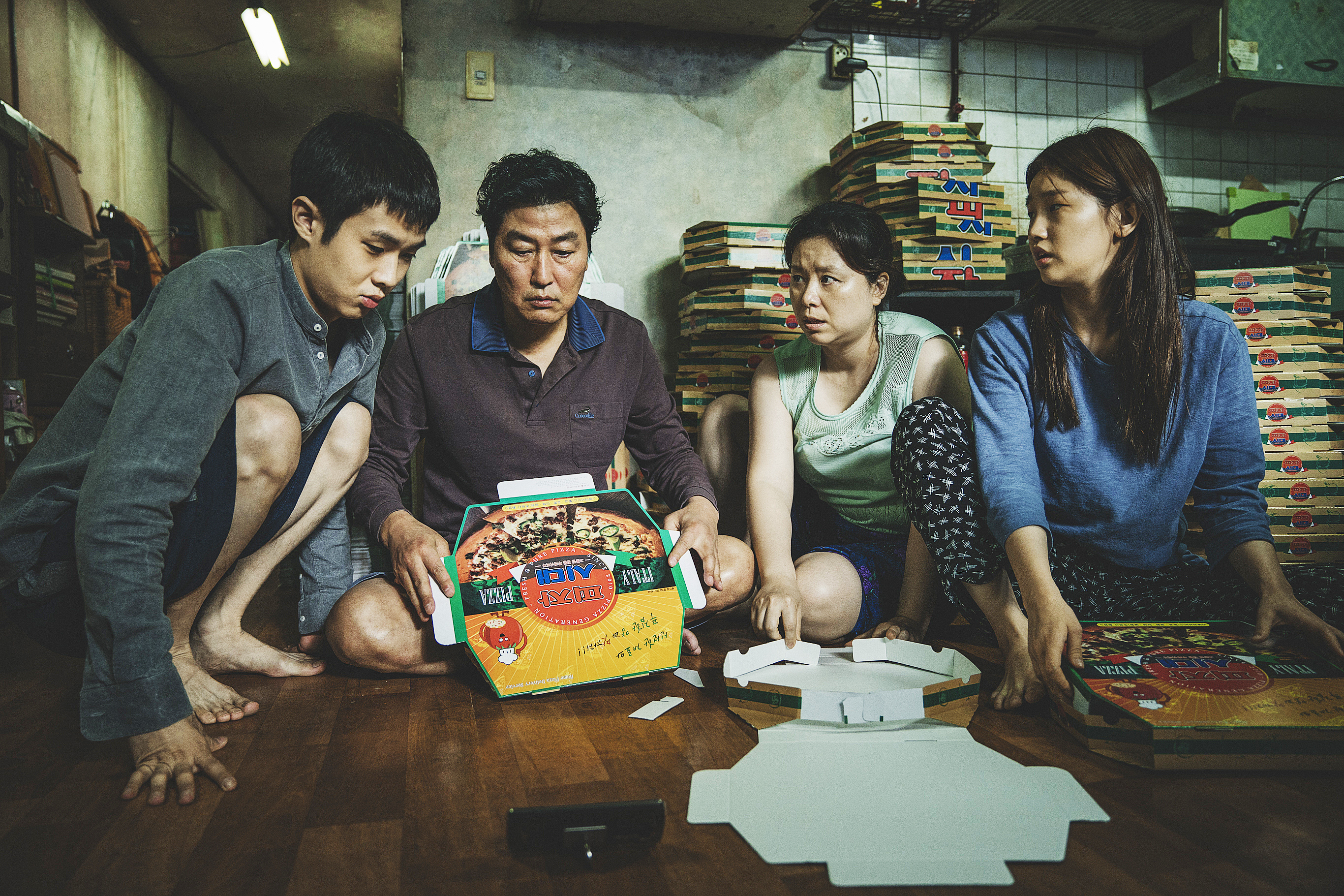 A screenshot of the Kim family starring at a toy in Parasite