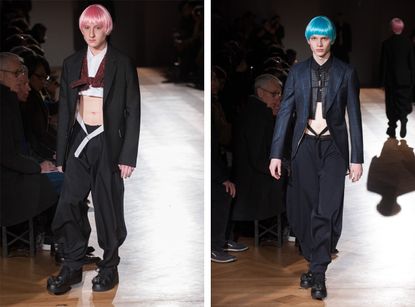 A front on view of two different models on the same catwalk, left pink hair and right blue hair
