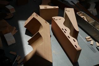 Wooden blocks cut from a single piece of wood, arranged on a work table at Max Lamb's studio