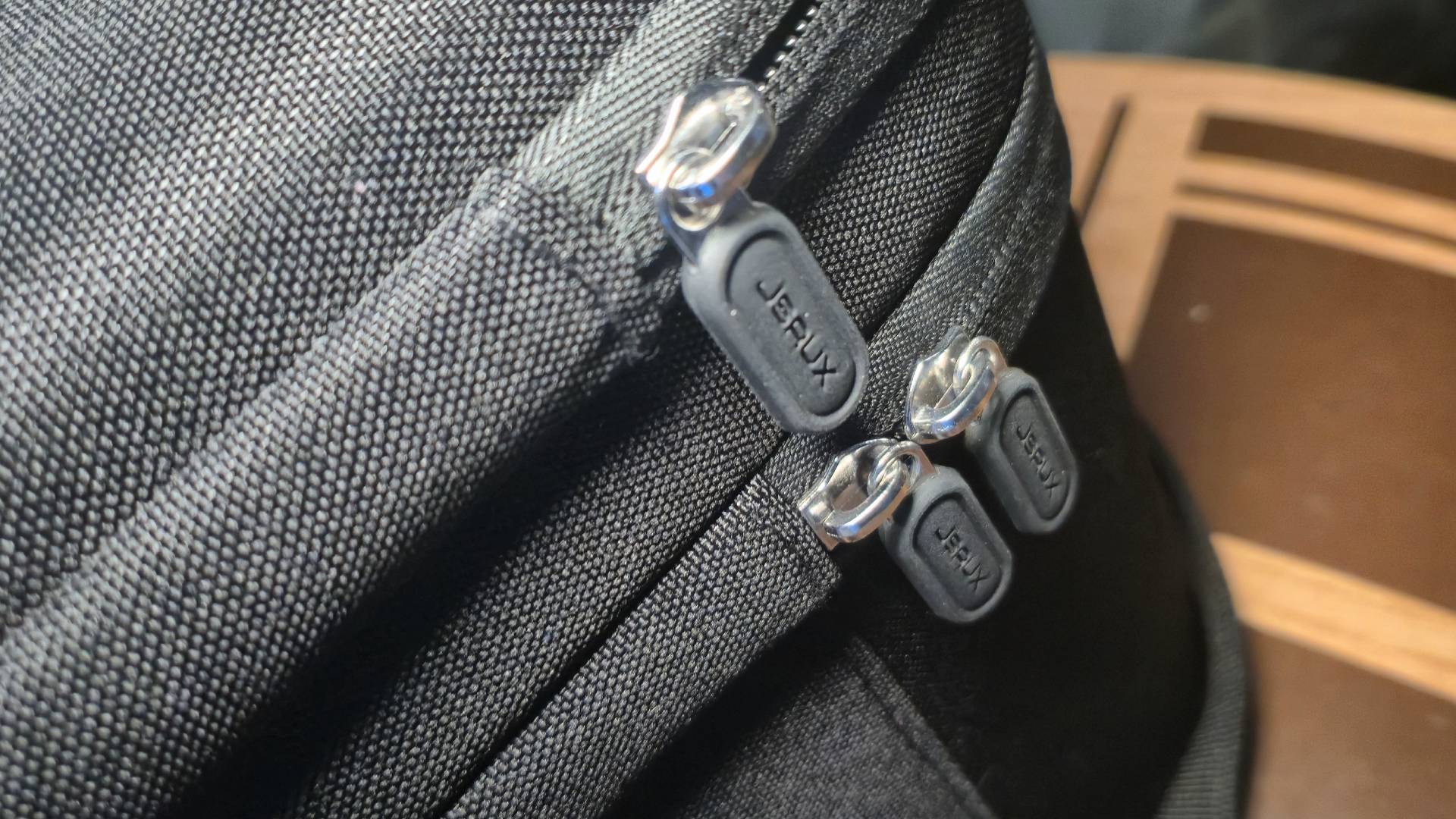 Photo close up of the JSAUX-branded zips.