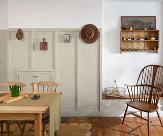 neutral rustic dining room with wall panelling and wooden flooring