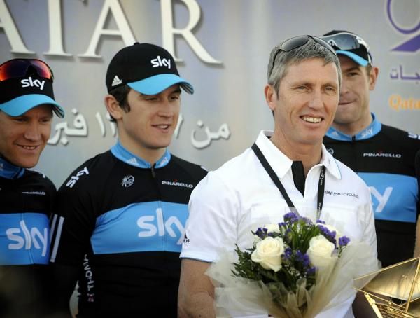Geraint Thomas and Team Sky directeur sportif Scott Sunderland celebrate the team's success on the podium