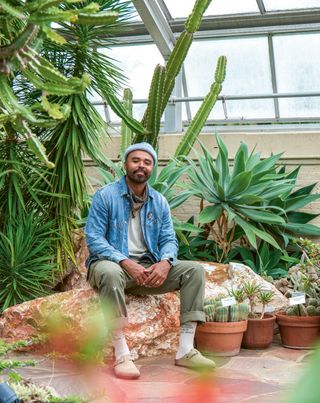Hilton Carter pictured beside lush green plants
