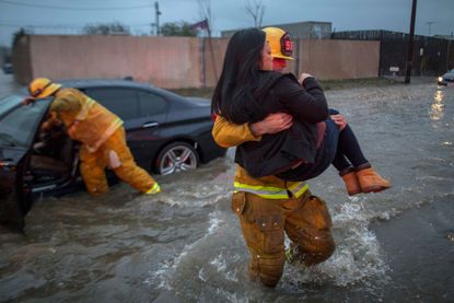 A woman is rescued from flooding in California