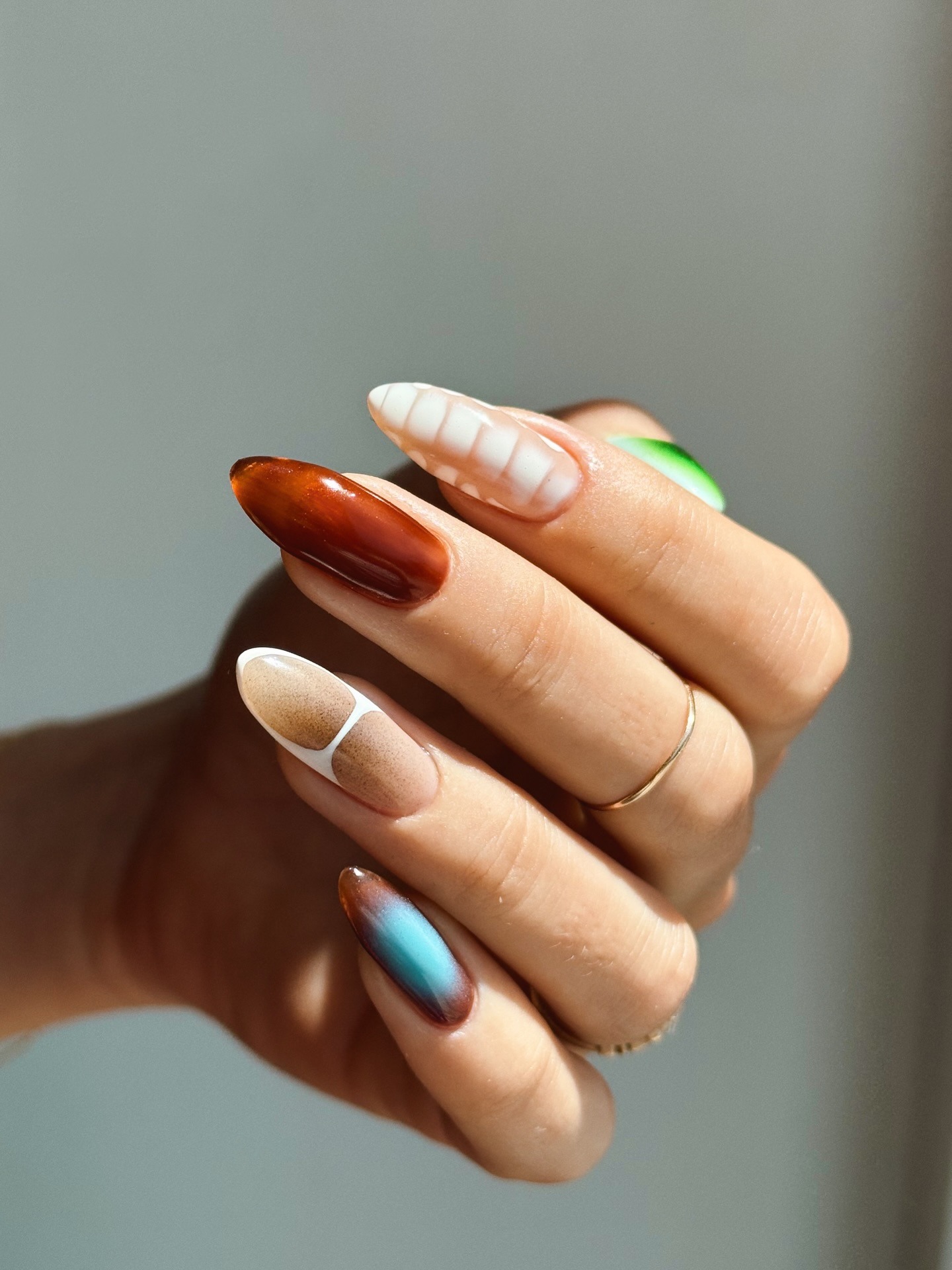 A close-up of a colourful, summery nail design