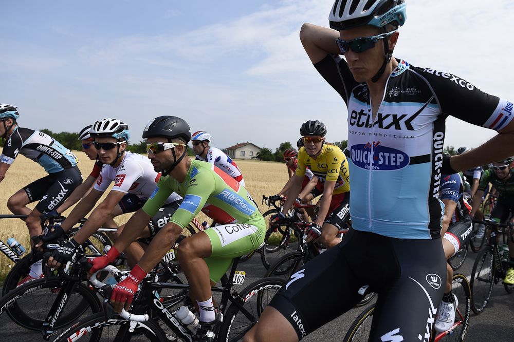 Rohan Dennis, wearing the overall leader's yellow jersey, and France's Nacer Bouhanni, wearing the best sprinter's green jersey, ride in the pack as they take the start of the 228 km fourth stage.
