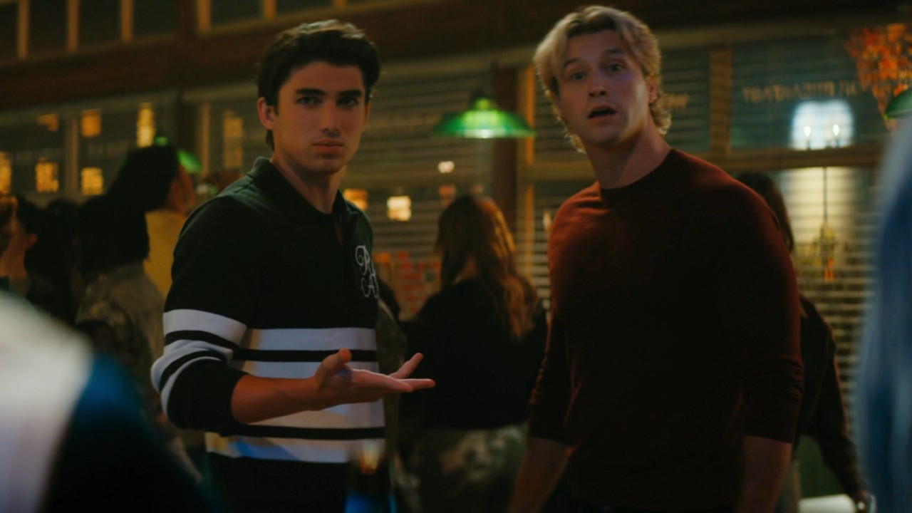 Hunter Davenport raising his arm up in question and Dean looking shocked in Off Campus.
