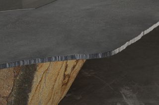 Detail of the materials used for the tables, including steel top and oxidised volcanic stone