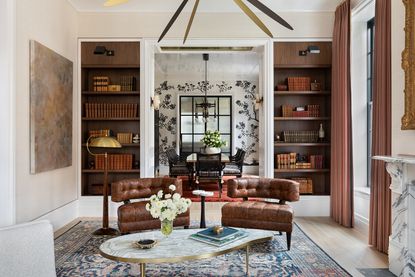 living room with tan leather chairs and gold accents