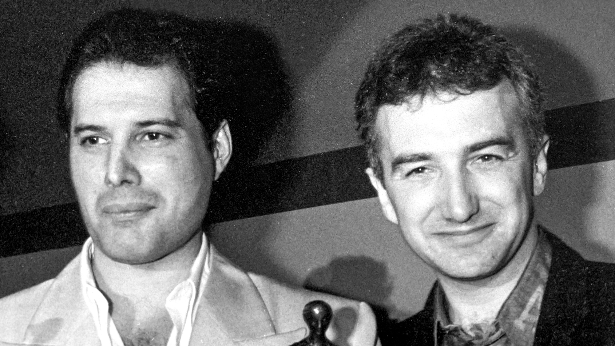 Freddie Mercury and John Deacon of Queen at the Ivor Novello Awards in May 1987 where Queen won the award for Outstanding Contribution to British Music