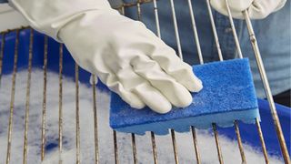 how to clean a BBQ with a specialist grill sponge and soapy water