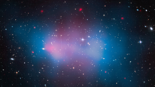 A view of space with blue and pink hazes overlaying lots of stars and galaxies.