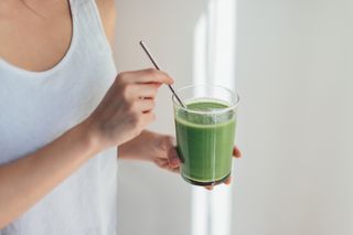 What to eat after a workout: woman drinking a protein shake