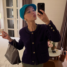 Iris Law takes a mirror selfie wearing khaki leggings with high-vamp heels, a button-down jacket with a blue cap.