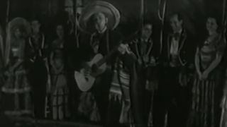 Tex Ritter playing guitar in Song of the Gringo