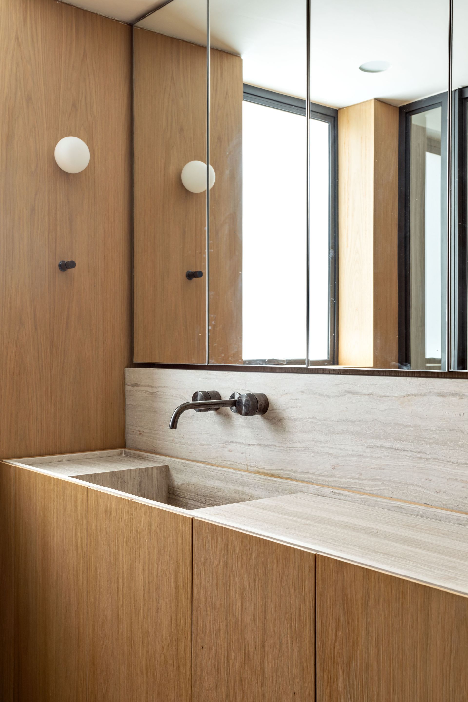 A small bathroom with wall sconces