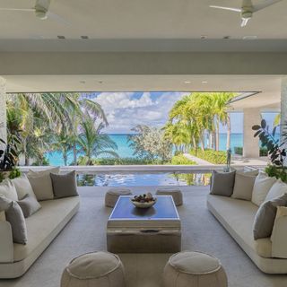 living area with sea view and sofa and cushions