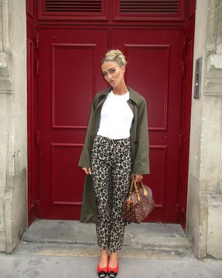 @emilisindlev wearing leopard print trousers, t-shirt and coat