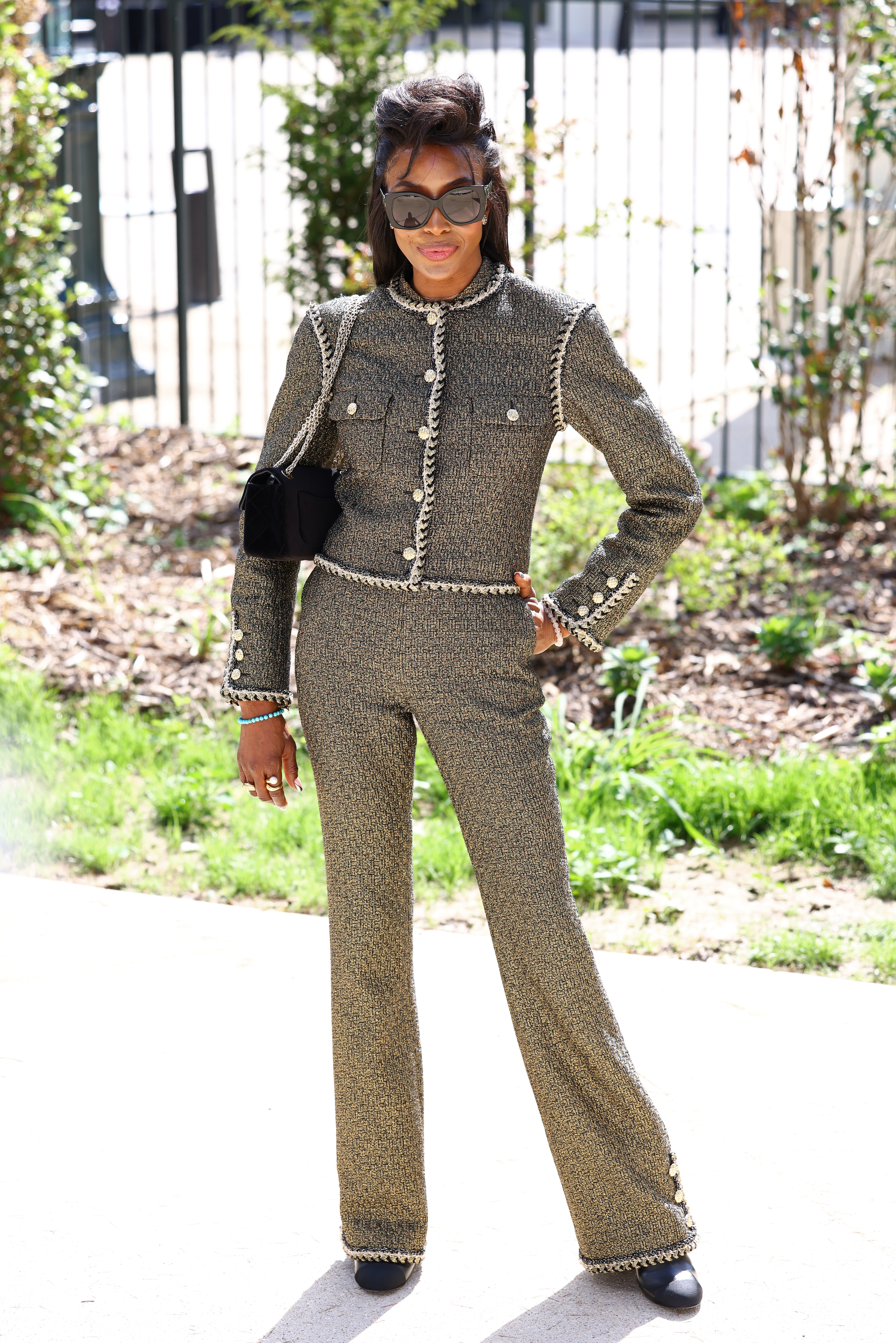 Naomi Campbell wore a tweed two-piece at the Chanel Haute Couture Week show.