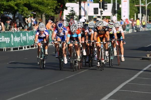 The riders in the bunch look at each other with three laps to go.