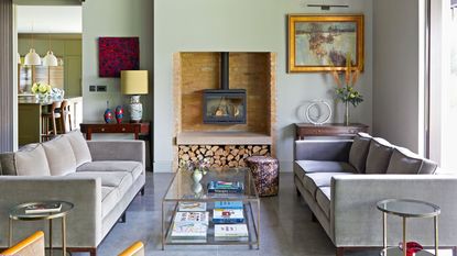 green living room with fireplace and grey sofas