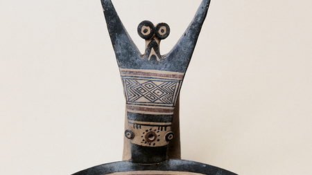 close-up of a human figurine with geometric decoration